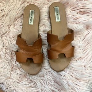 Slightly worn Steve Madden slides in brown.